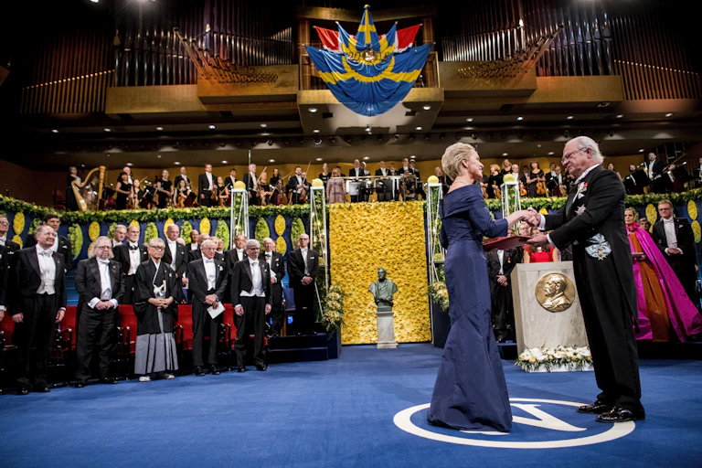Arnold receiving award in ceremony on stage