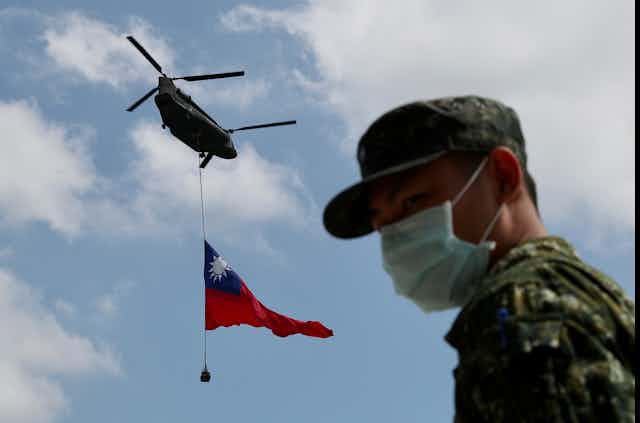 A chinook helicopter hoists a giant Taiwan flag during a Taiwan flag flyby rehearsal ahead of Taiwan National Day.