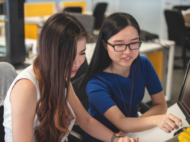 Women look at a computer