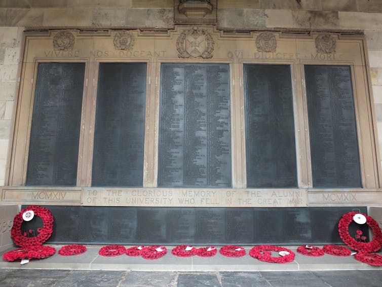 Poppy wreaths lie at the foot of the Old College war memorial at the University of Edinburgh