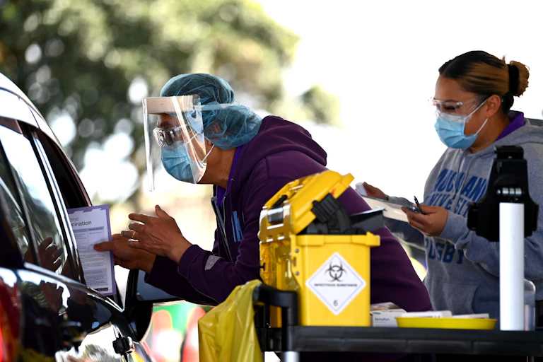 Vaccination team providing COVId-19 vaccinesin a drive-through clinic.
