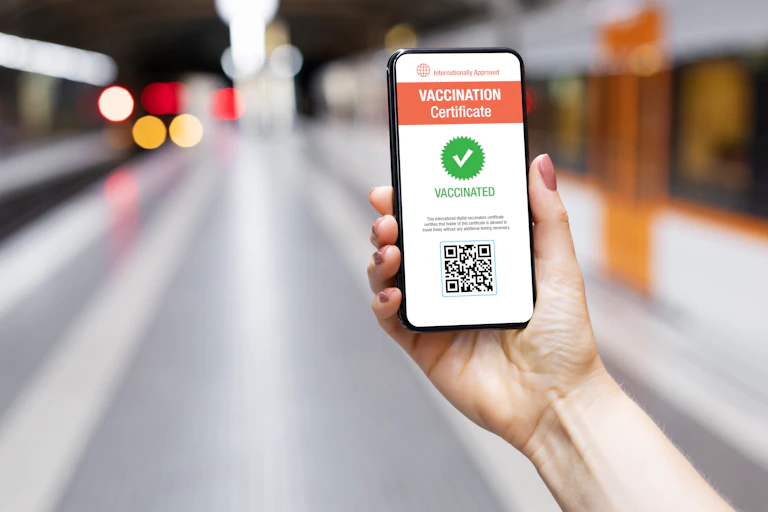Person holding a vaccine certificate on their smartphone