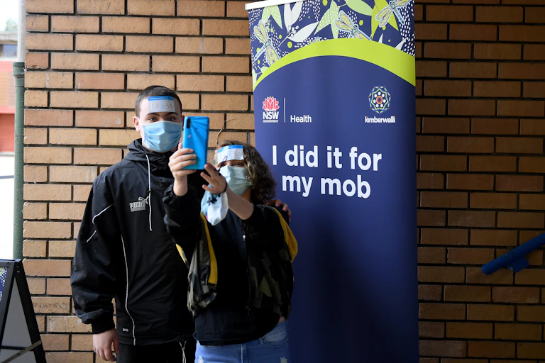 People take a selfie after receiving a COVID vaccine at an Aboriginal vaccination Hub in Whalan, west of Sydney.
