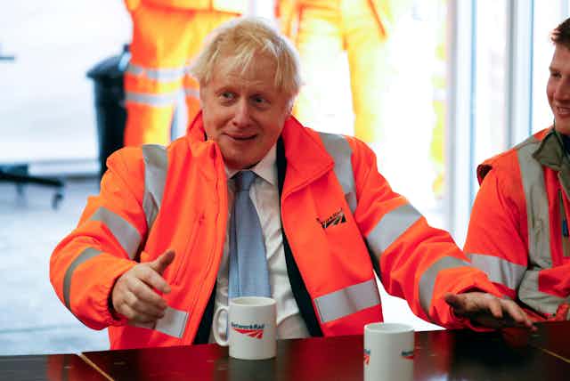 Boris Johnson drinking a cup of tea on a visit to Network Rail.