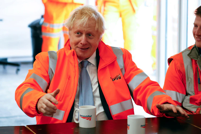 Boris Johnson drinking a cup of tea on a visit to Network Rail.