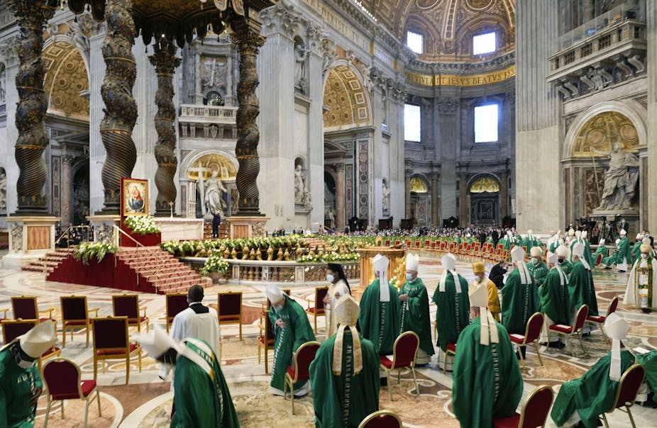 Bishops dressed in green and white wait for the arrival of Pope Francis at a mass to open the synod in St. Peter's Basilica at the Vatican on Oct. 10, 2021.