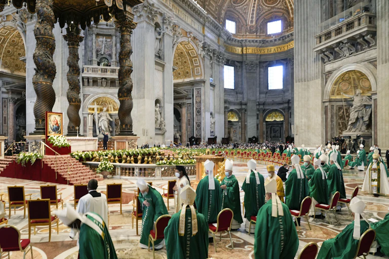 Bishops dressed in green and white wait for the arrival of Pope Francis at a mass to open the synod in St. Peter's Basilica at the Vatican on Oct. 10, 2021.