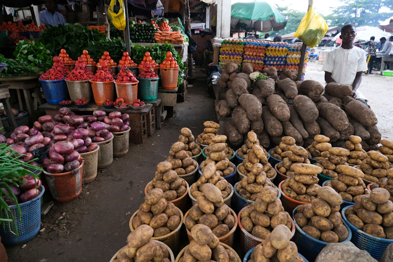 Man stands next to displayed food items