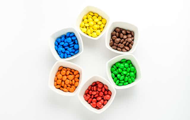Bowls of colourful candies in a circle.