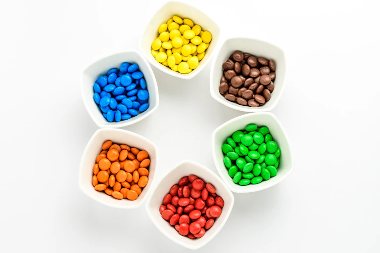 Bowls of colourful candies in a circle.