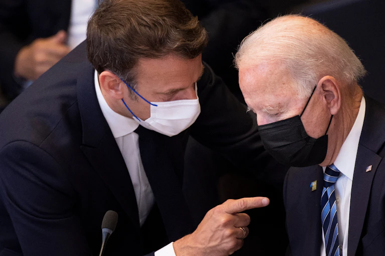Emmanuel Macron talks to Joe Biden