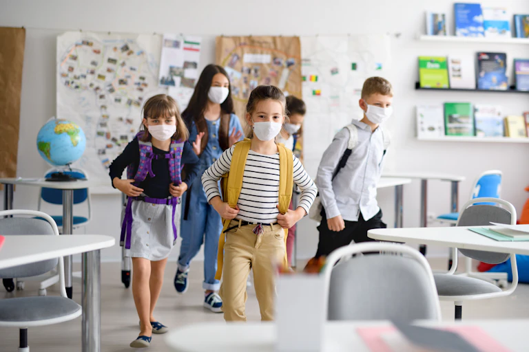 Children wearing masks enter classroom
