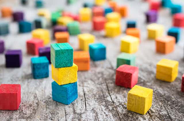 Multicoloured building blocks scattered around.