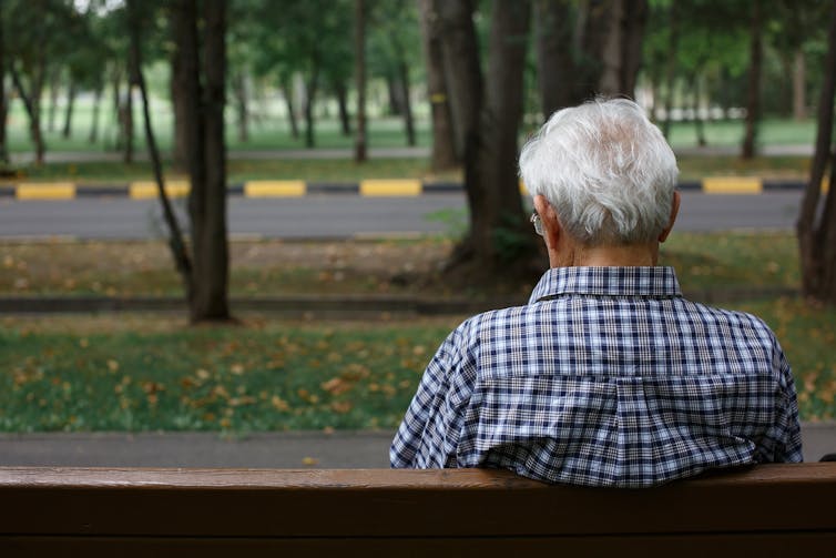 Old man sitting on a park bench.