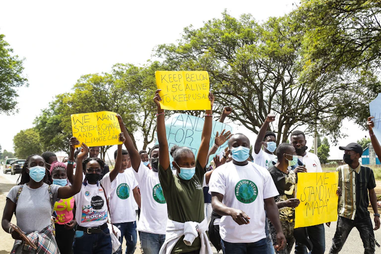 Activists hold placards during a protest in Kenya.