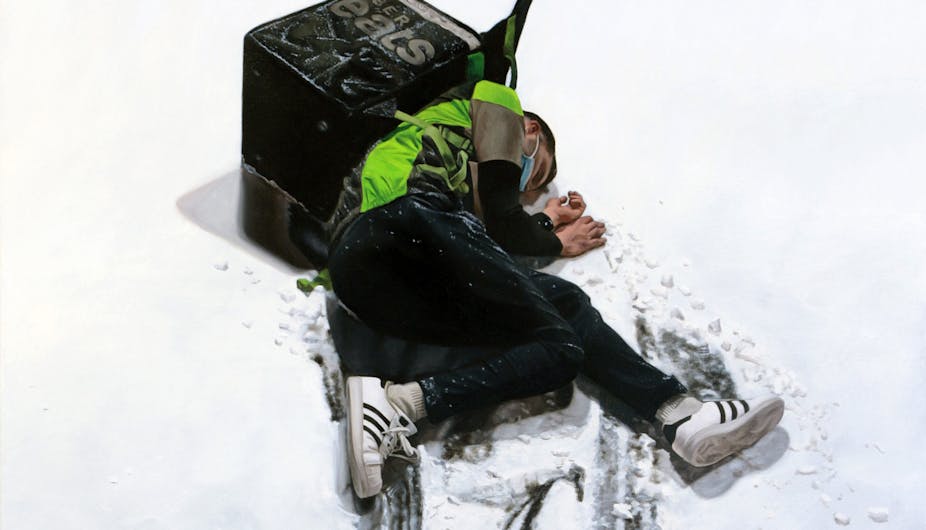 Un livreur Uber Eats à terre,  dans la neige. Il est inconscient et semble blessé.