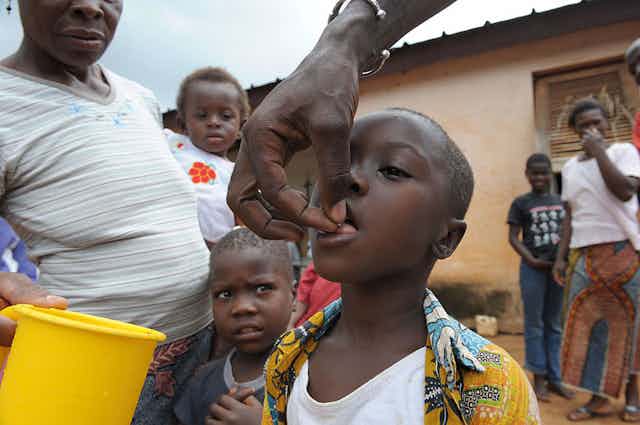 Nurse giving ivermectin to a child in the Ivorian town of Kouadioa-Allaikro