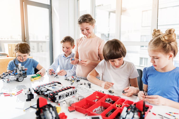 Boys and girls play with lego.