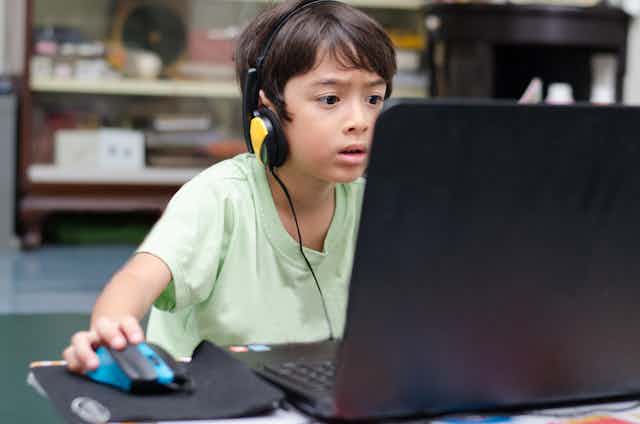 Boy playing computer game.