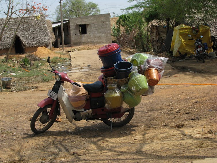 A motorbike with plastic containers and packaging attached