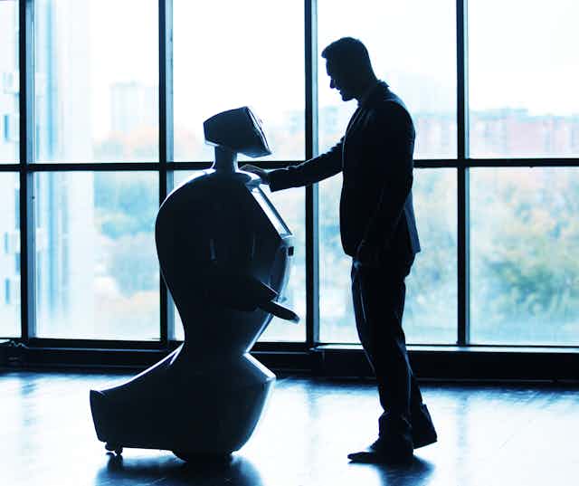 A man interacting with a robot