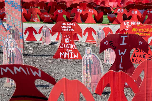 Cardboard red dresses mark a memorial to missing and murdered Indigenous women
