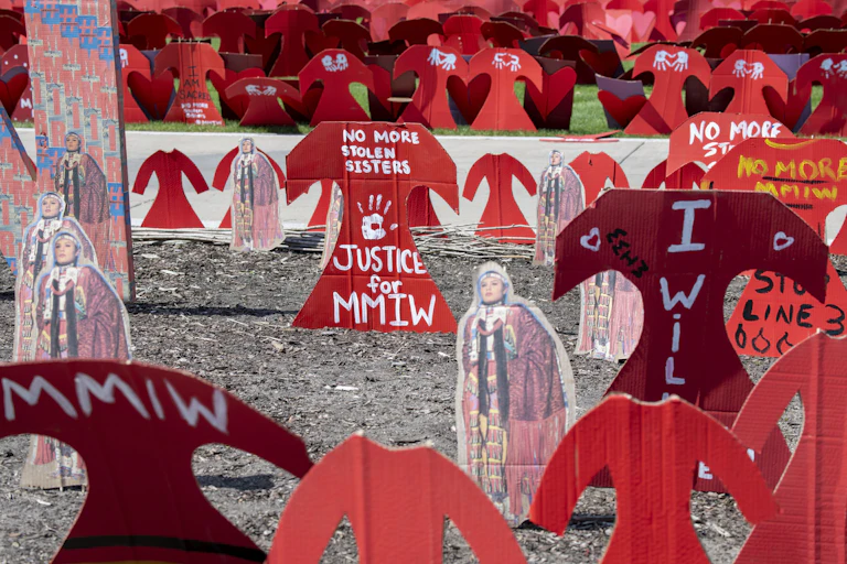 Cardboard red dresses mark a memorial to missing and murdered Indigenous women