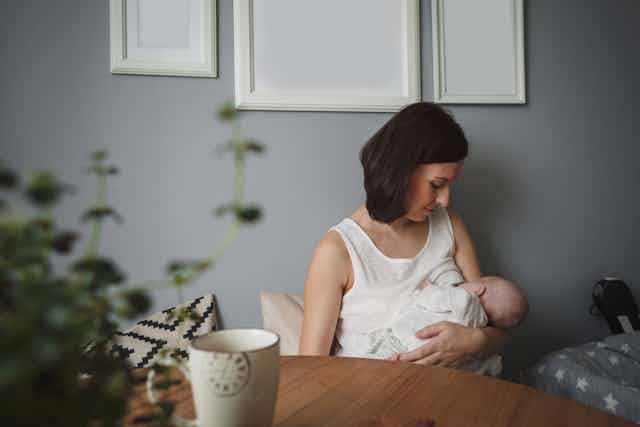 A woman breastfeeding a baby.
