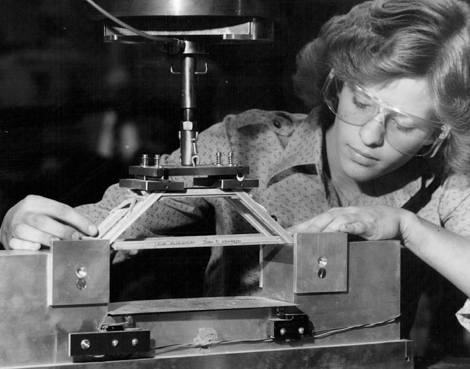 Black and white photo of a woman with protective eyewear with a model bridge.