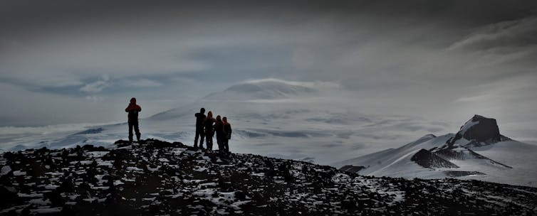 People standing on a ridge in Antarctica.