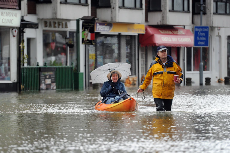 Woman in canoe on flooded street