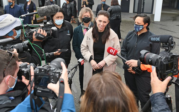 Jacinda Ardern talking to reporters outdoors