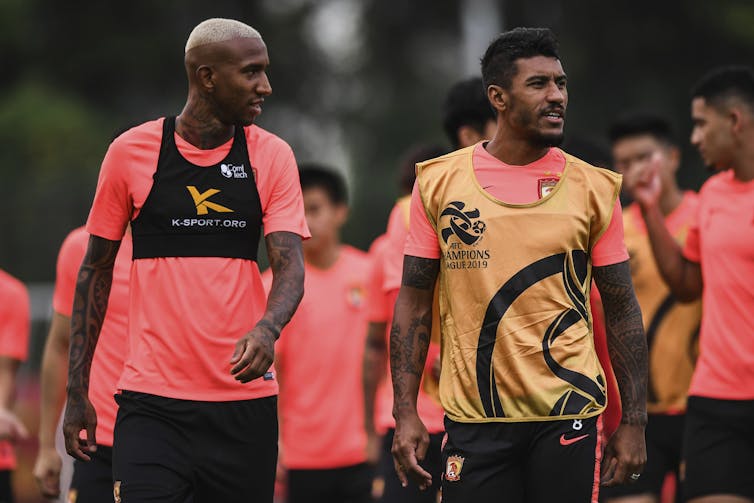 Brazilian footballers Talisca and Paulinho.