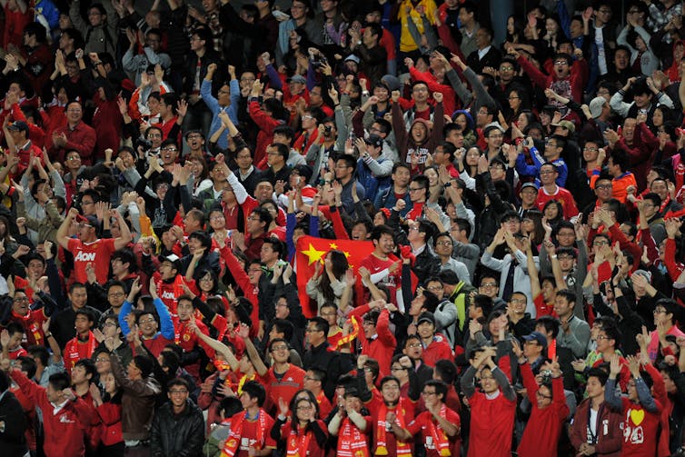 Guangzhou Evergrande fans celebrate a goal.
