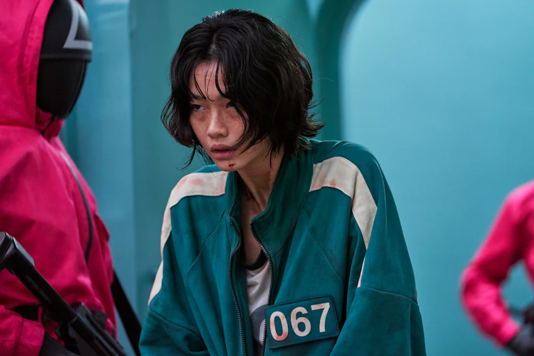 Woman in tracksuit with wounds.