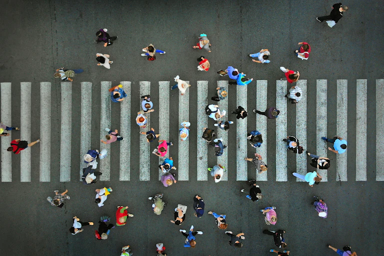 People walking over a zebra crossing, from above