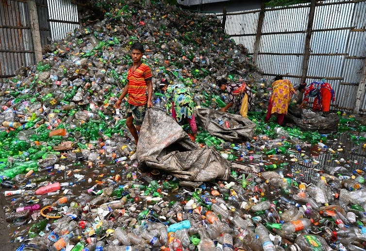 People pick waste from a landfill