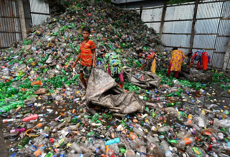 People pick waste from a landfill