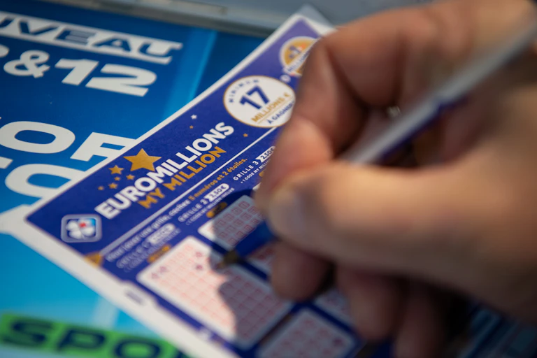 Close-up photo of someone's hand completing a Euromillions ticket