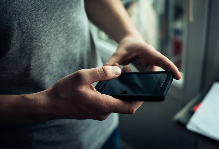 Hands using a smartphone.