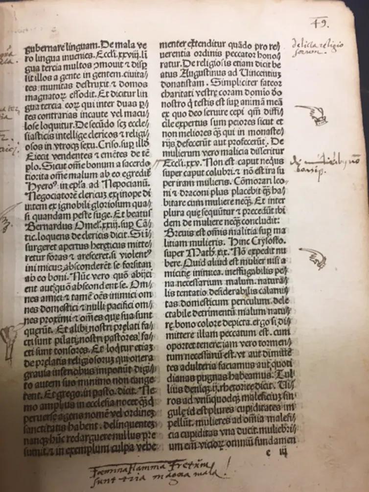 Handwritten notes dot the sides of a page from a medieval book.