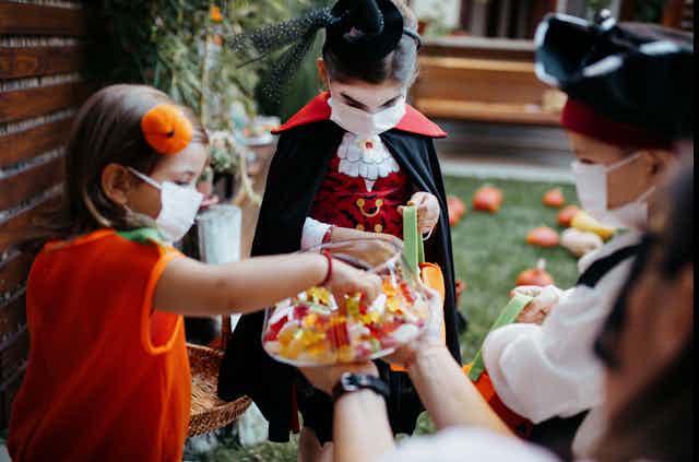 Kids dressed in Halloween costumes trick or treat