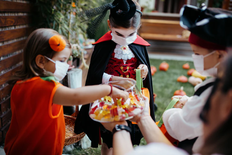 Kids dressed in Halloween costumes trick or treat