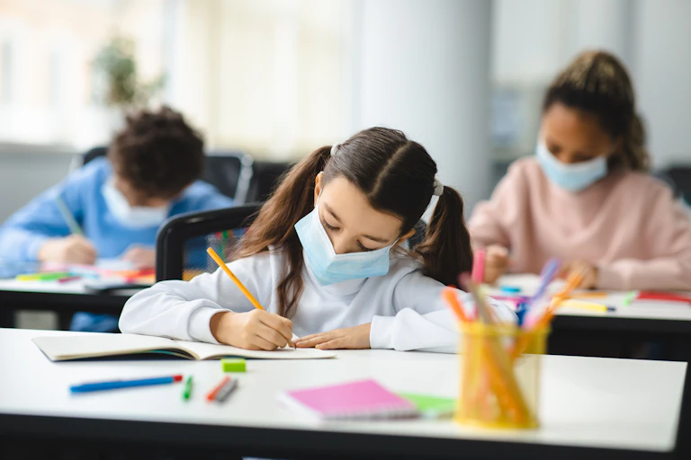 Kids in class with masks on.