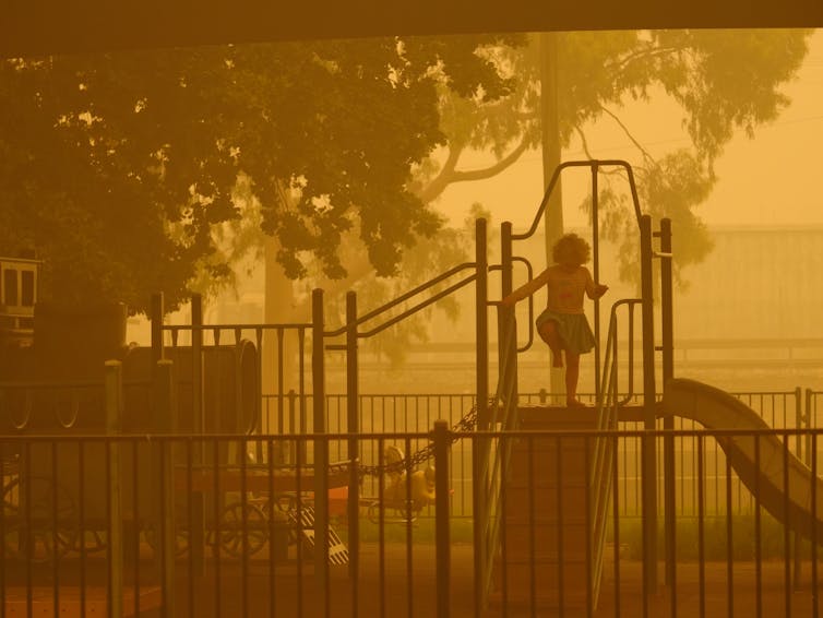 A playground seen through smoke haze