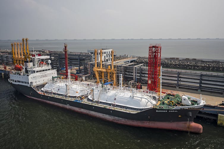 Large industrial ship at a loading bay.