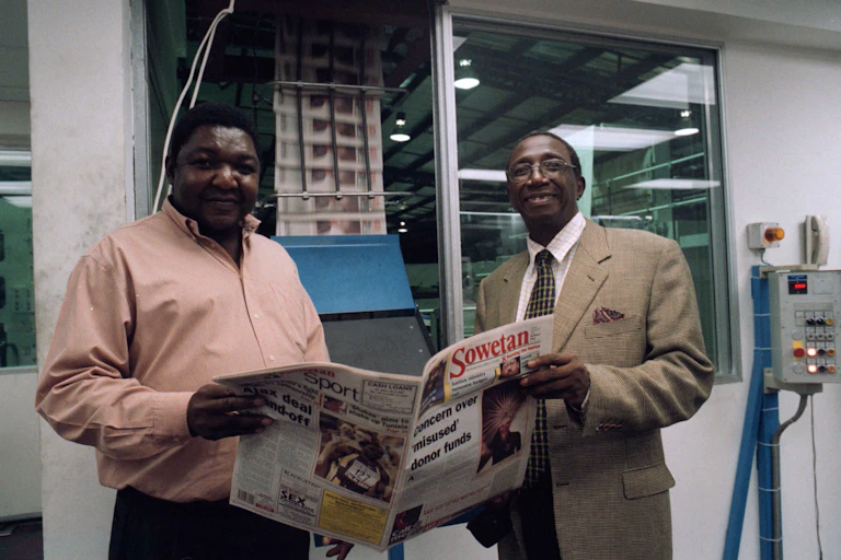 Aggrey Klaaste, right, used the Sowetan newspaper to drive his Nation-building campaign. He is seen here with John Mabato, the newspaper's production manager.