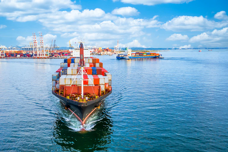 A container ship leaving a busy port.