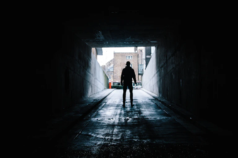 Man at the mouth of a dark passage