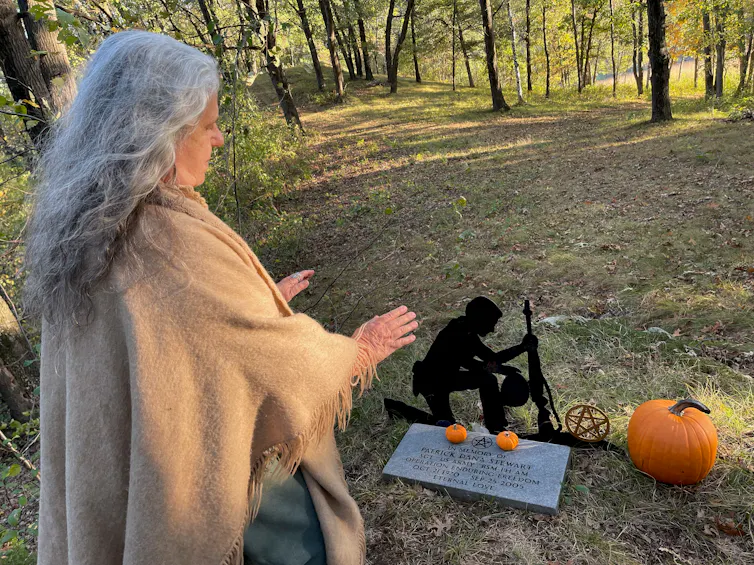The Rev. Selena Fox of Circle Sanctuary does a ritual of remembrance at the grave of a Wiccan soldier killed in Afghanistan.